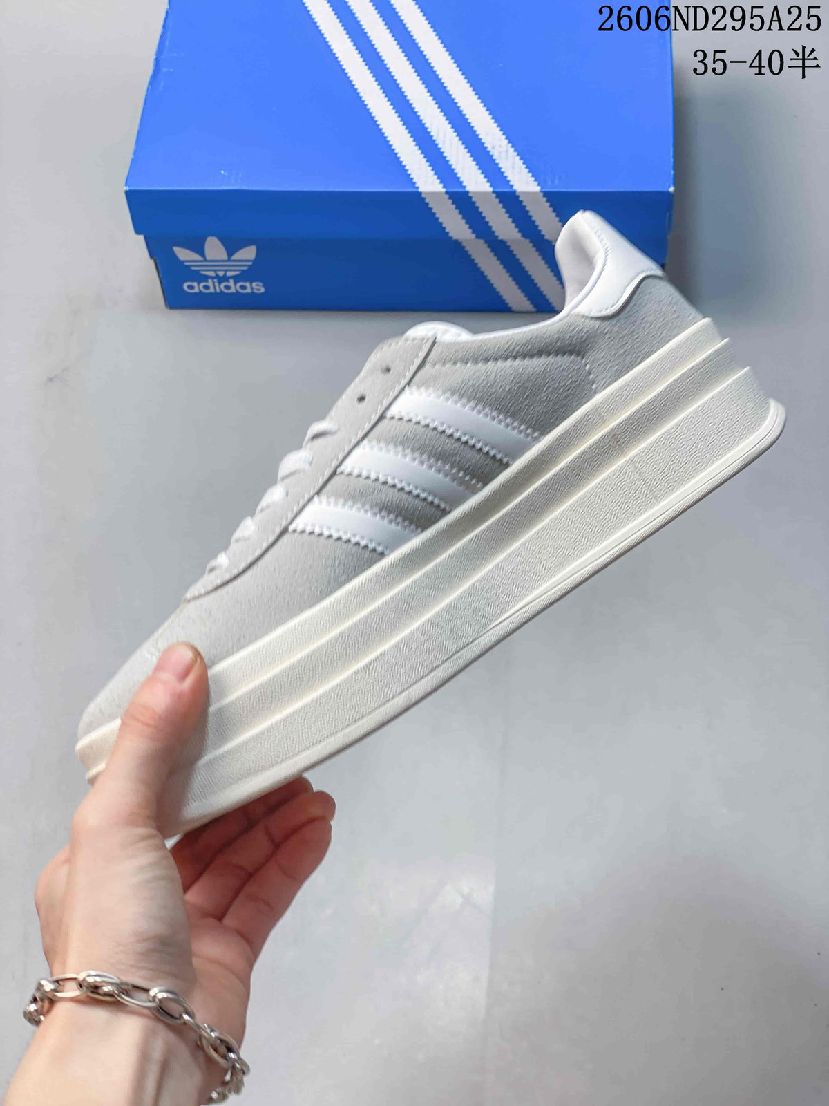 Side profile showing the white three stripes, suede-look upper and platform sole.
