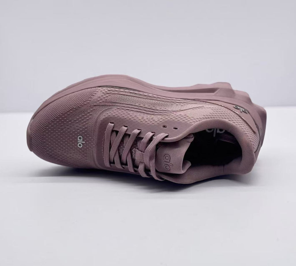 Top view of a pink alo sneaker highlighting the lacing system and textured upper.