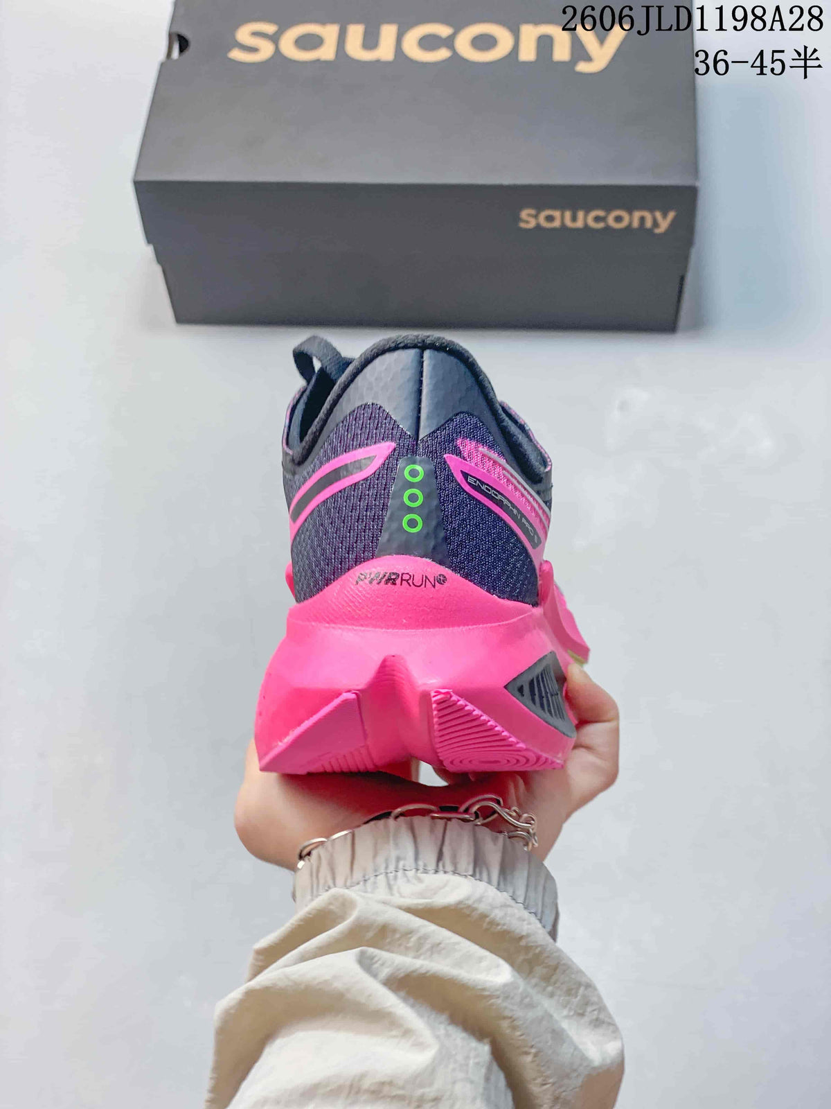 Rear view of a navy and pink Saucony running shoe
