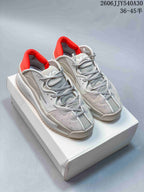 Pair of white and grey Y-3 Rivalry sneakers with red collar accents