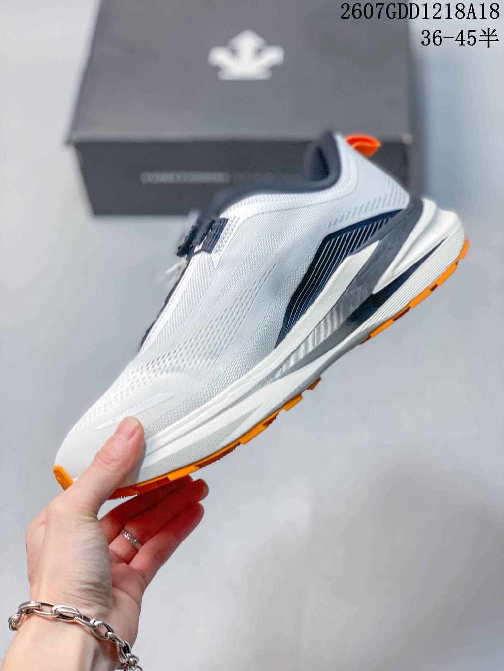 Side view of the white running shoe showing navy structural detailing and the layered midsole.