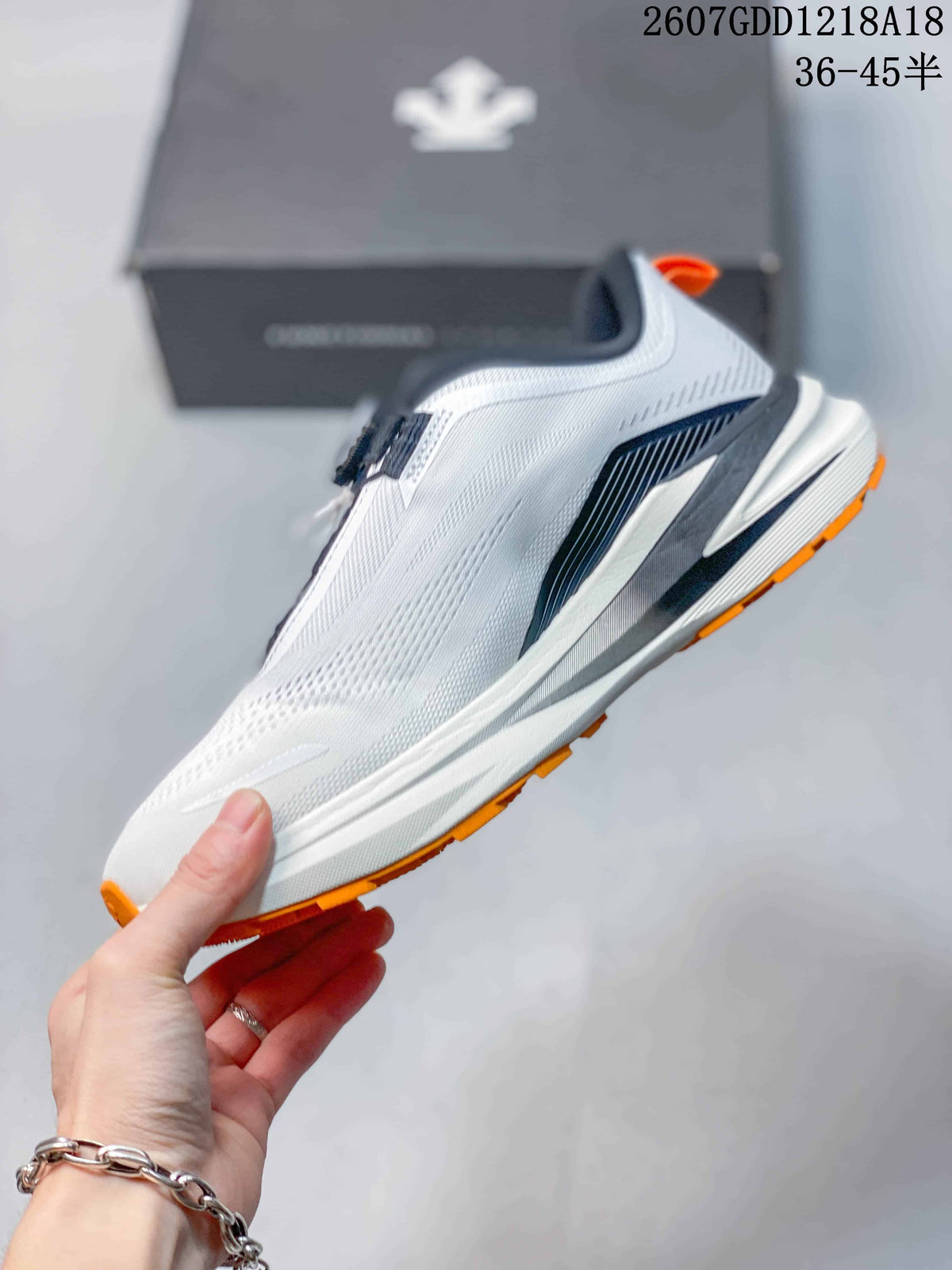 Side view of the white running shoe showing navy structural detailing and the layered midsole.