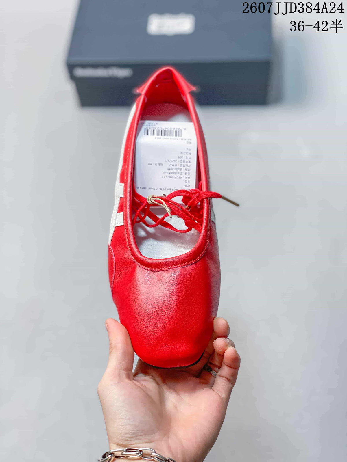 Top view of the red shoe showing its rounded toe, lace-up opening, white side detailing, and interior label.