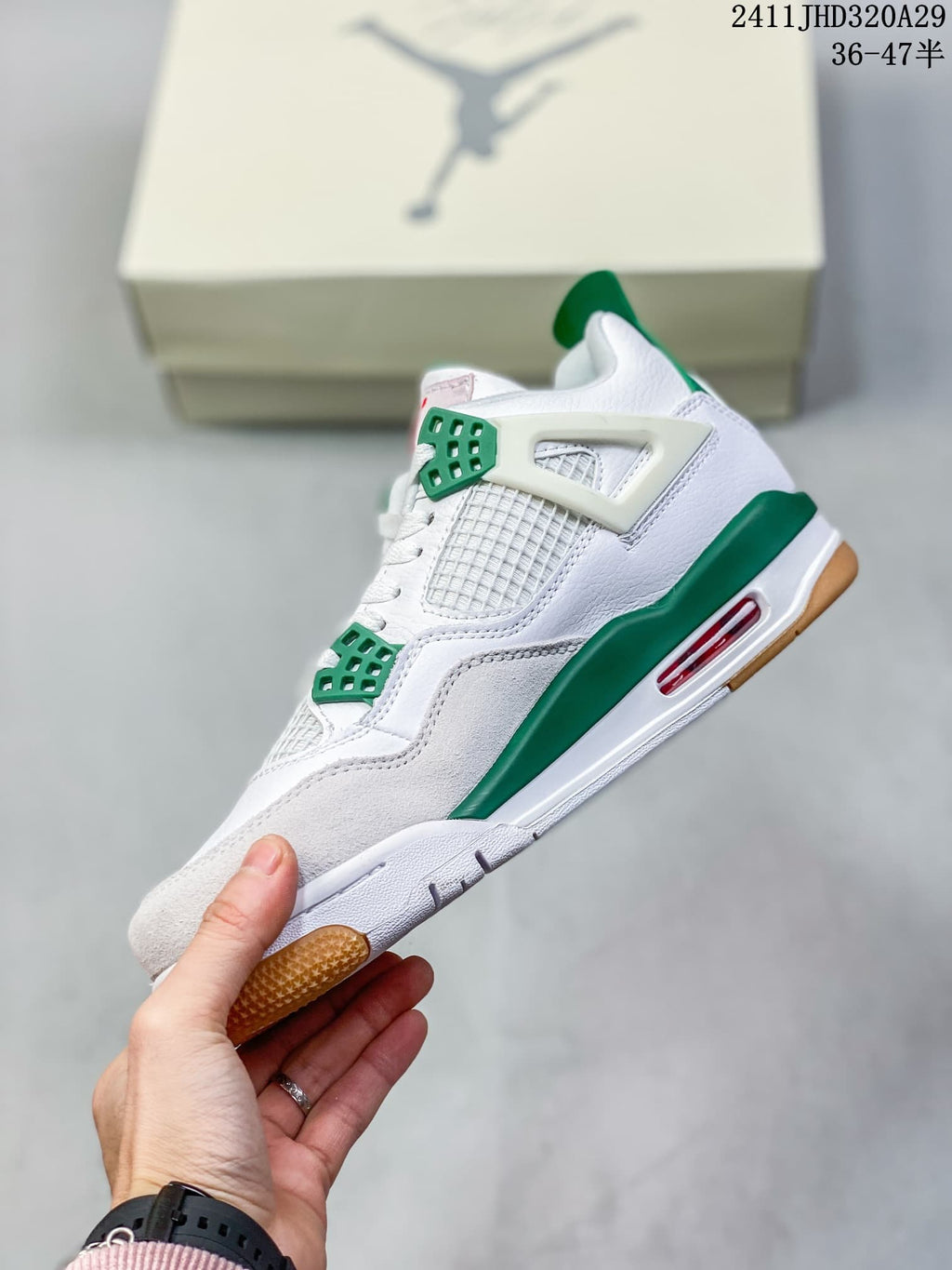 Side view of a white high-top sneaker with green accents, mesh paneling, red outsole detail, and a gum-colored outsole edge.
