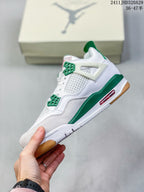 Side view of a white high-top sneaker with green accents, mesh paneling, red outsole detail, and a gum-colored outsole edge.