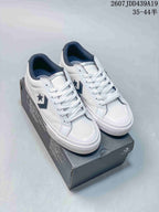 White Converse low-top sneakers with dark star-and-chevron side logos displayed on a shoebox; image text shows style code 2607JDD439A19 and size range 35–44.5.