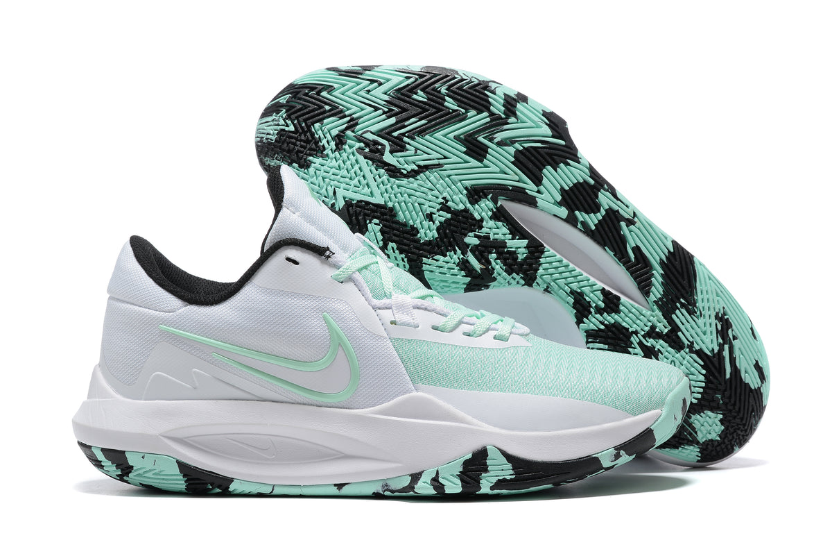 White and mint basketball shoe with a black-and-mint patterned outsole.