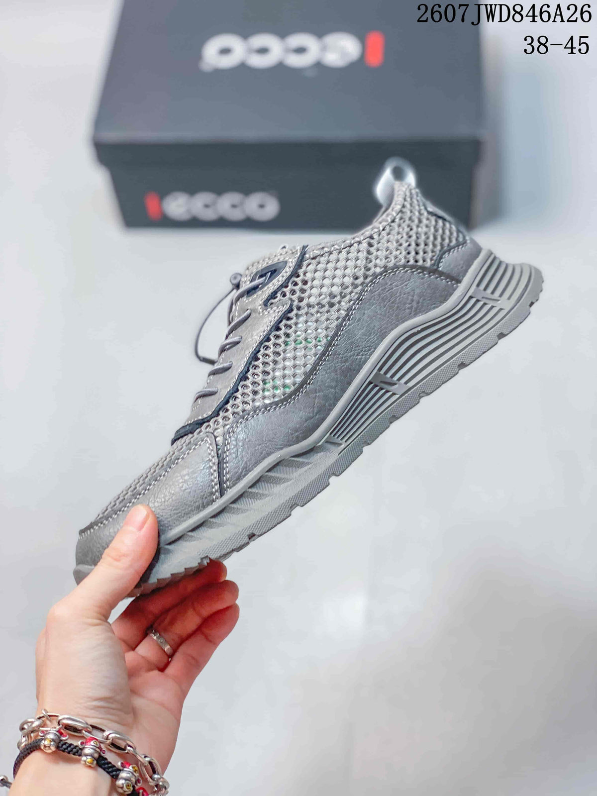 Side view of the grey sneaker showing mesh panels, structured overlays and the textured sole.