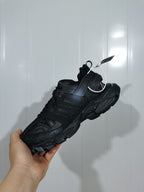 Top and rear angled view of the black Balenciaga Track sneaker showing its layered construction and textured sole.