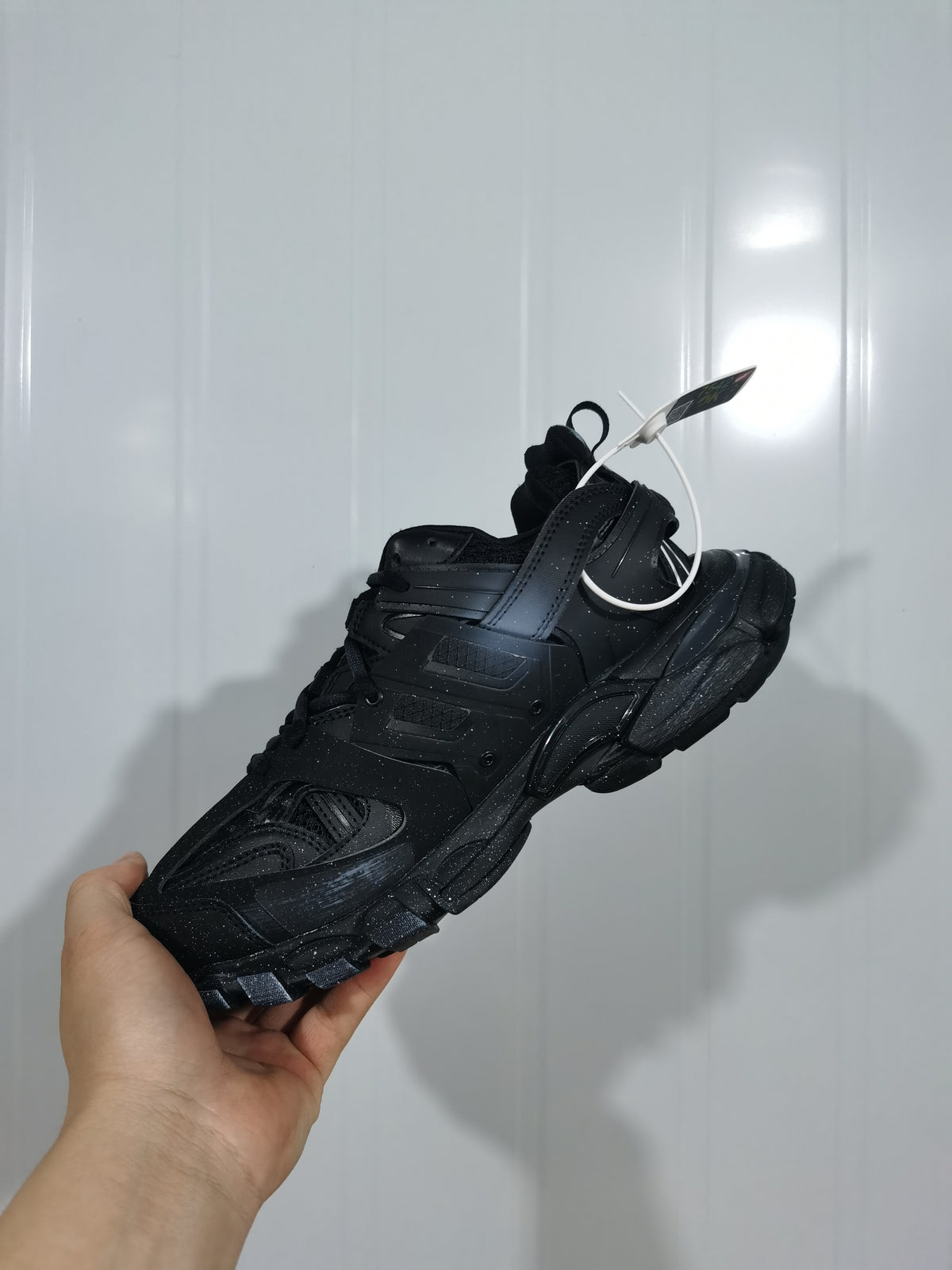 Top and rear angled view of the black Balenciaga Track sneaker showing its layered construction and textured sole.