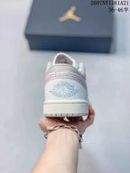 Rear view showing the embroidered Jordan Wings logo, pink heel accent and textured outsole edge.