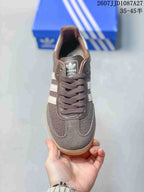 Top view showing the rounded toe, brown laces, tongue branding, and white side stripes.