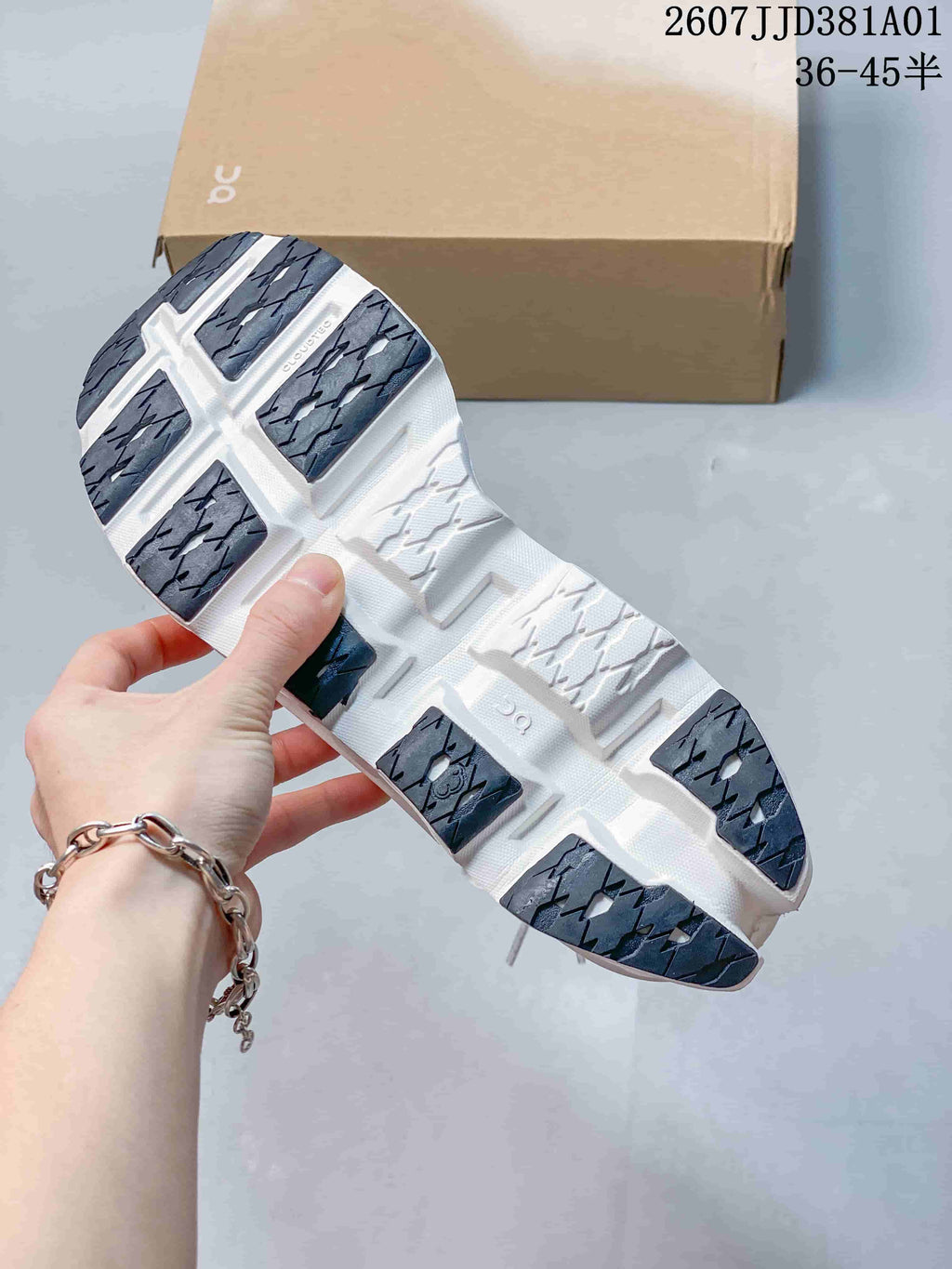 Close-up of the running shoe outsole with dark tread sections and sculpted grooves