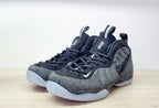 Pair of black and grey Nike Air Foamposite Pro Fleece sneakers shown from the front and side