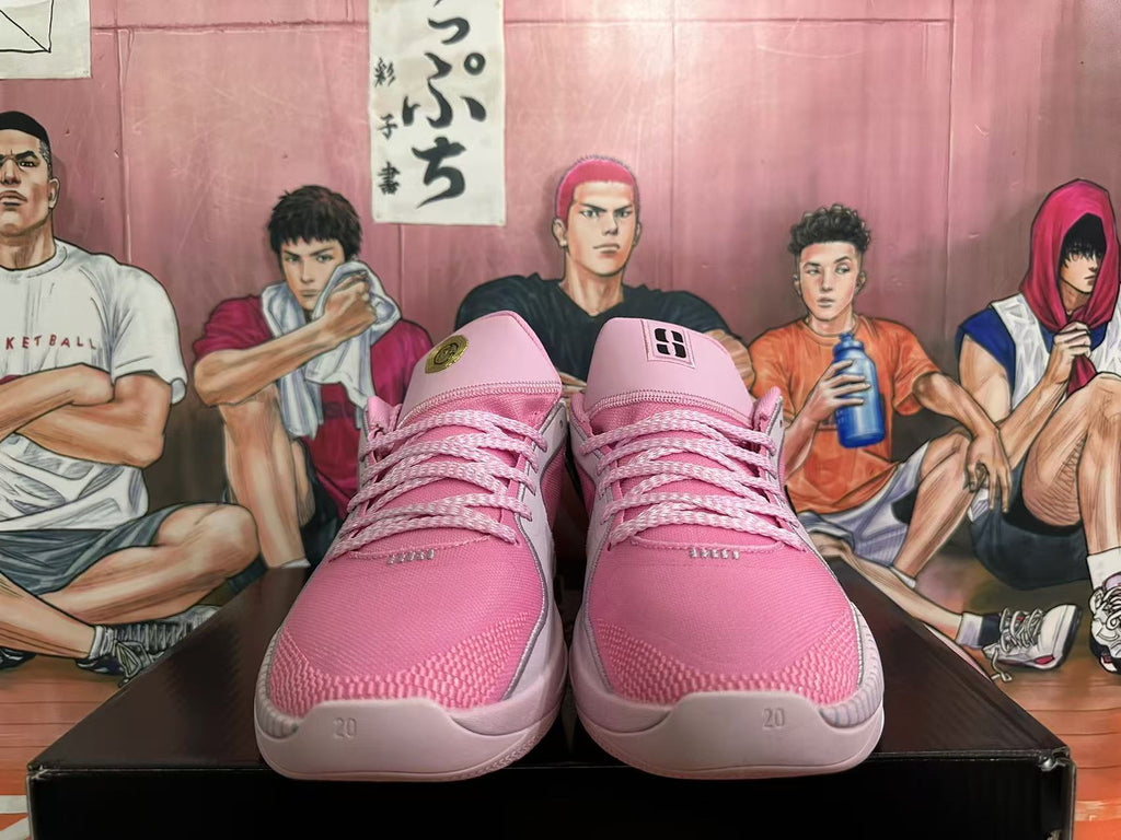 Front view of pink basketball shoes with pink laces and tongue details.