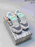 Pair of grey and navy Premiata sneakers with mint-green tongue accents, orange heel details and a patterned shoebox; image text shows 2607 TYD110A20 and 38–46.