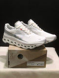 White On Cloudmonster 1 sneakers displayed on a branded shoe box in a three-quarter view.
