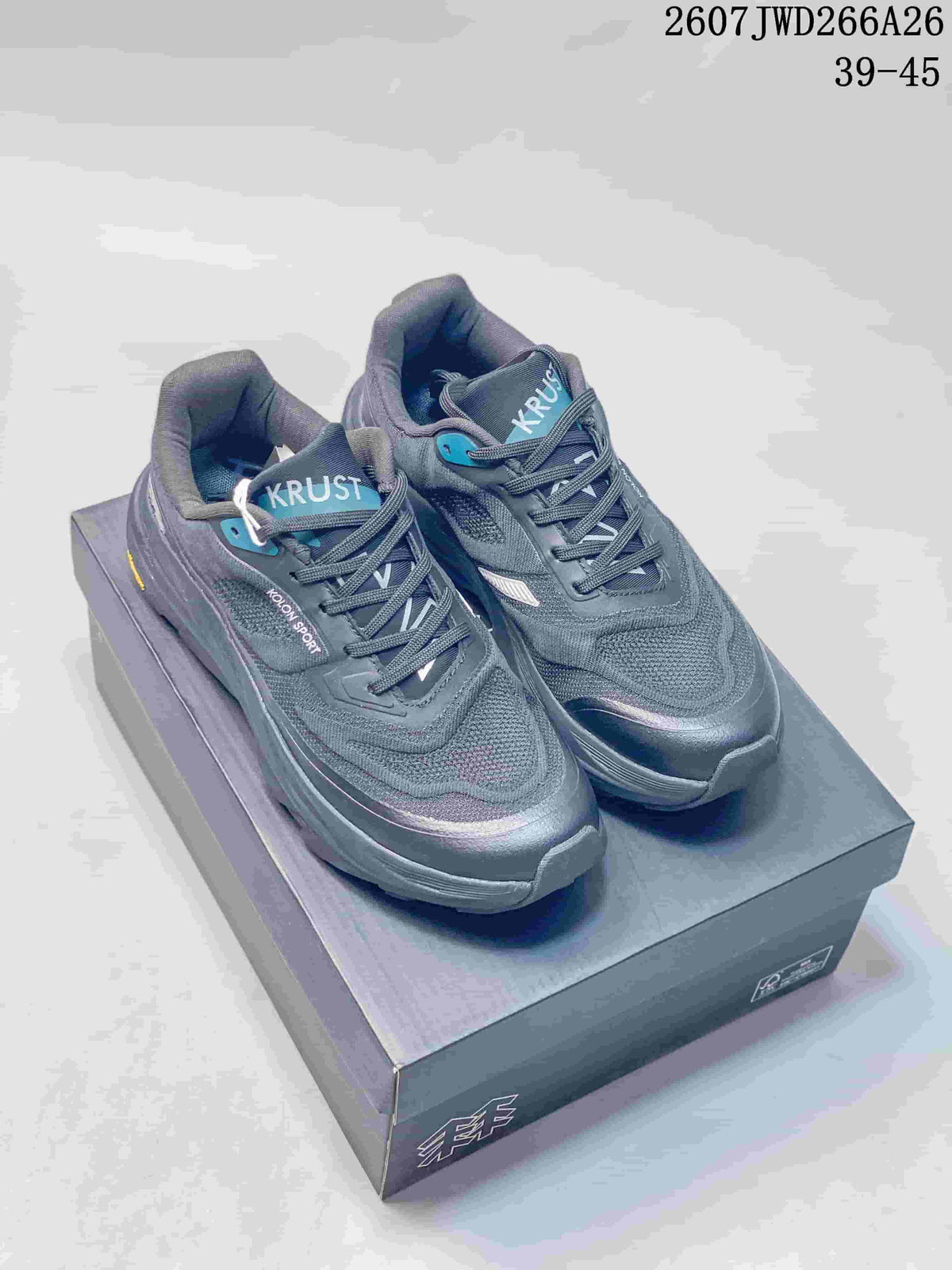 Pair of dark KOLON SPORT KRUST trail running shoes displayed on a shoebox, with style code 2607 JWD266A26 and EU size range 39–45 visible at the top.