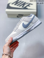 Side profile showing the darker grey Swoosh, off-white panels, white midsole, and grey outsole.