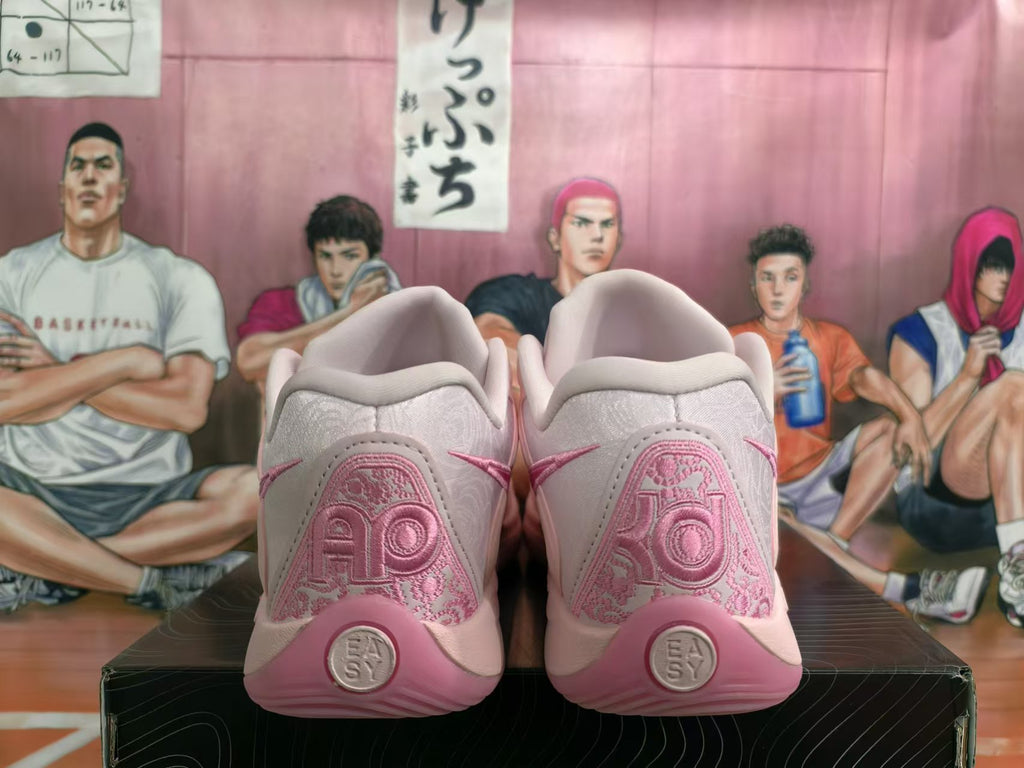 Rear view of pink Nike basketball shoes with embroidered heel graphics and darker pink accents.