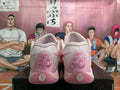 Rear view of pink Nike basketball shoes with embroidered heel graphics and darker pink accents.