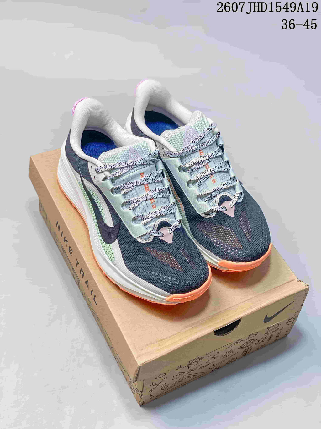 Pair of Nike Zoom Fly 5 shoes in navy, white, mint green and orange, displayed on a Nike shoebox; image text shows style code 2607JHD1549A19 and size range 36–45.