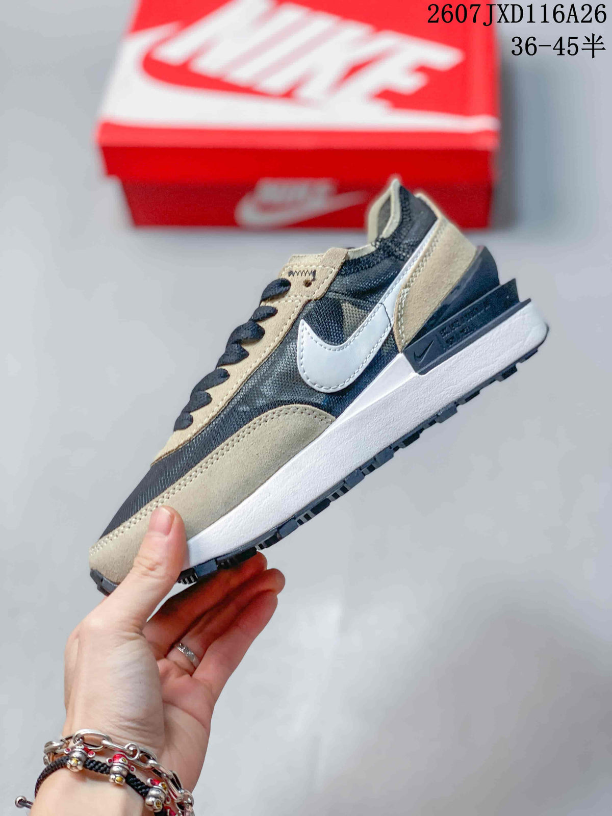 Side profile of the low-top sneaker showing the white Swoosh, brown overlays, dark mesh panels, and white midsole.
