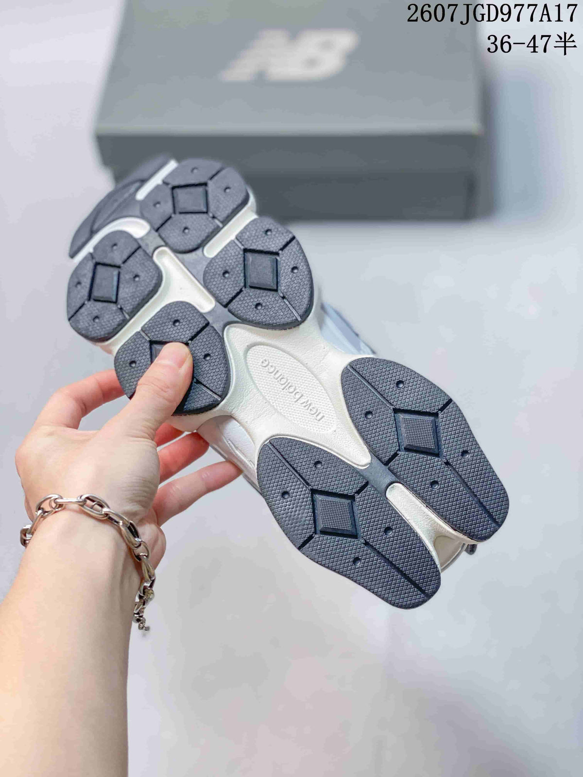 Underside view showing the segmented dark rubber outsole and sculpted sole structure.