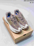 Pair of taupe-gray and white Nike Zoom Vomero Roam sneakers displayed on a shoebox, with the style code and size range visible above.