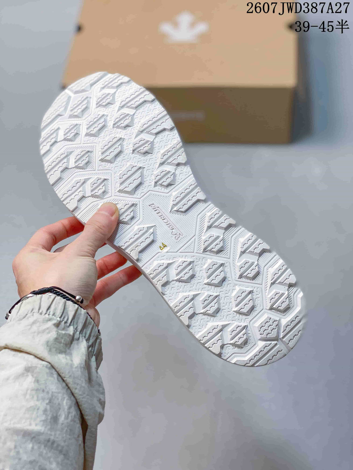 Close view of the white patterned outsole with geometric tread.