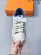 Top view of the sneaker showing white laces, perforated toe box, navy collar lining, and branding details.