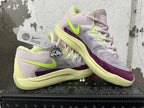 Pair of Nike basketball shoes displayed at an angle, showing the side panels and purple forefoot accents.