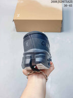 Rear view showing the heel and sculpted sole of a charcoal running shoe.