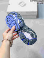 Close view of the sneaker outsole showing blue and black tread sections with a white midsole.