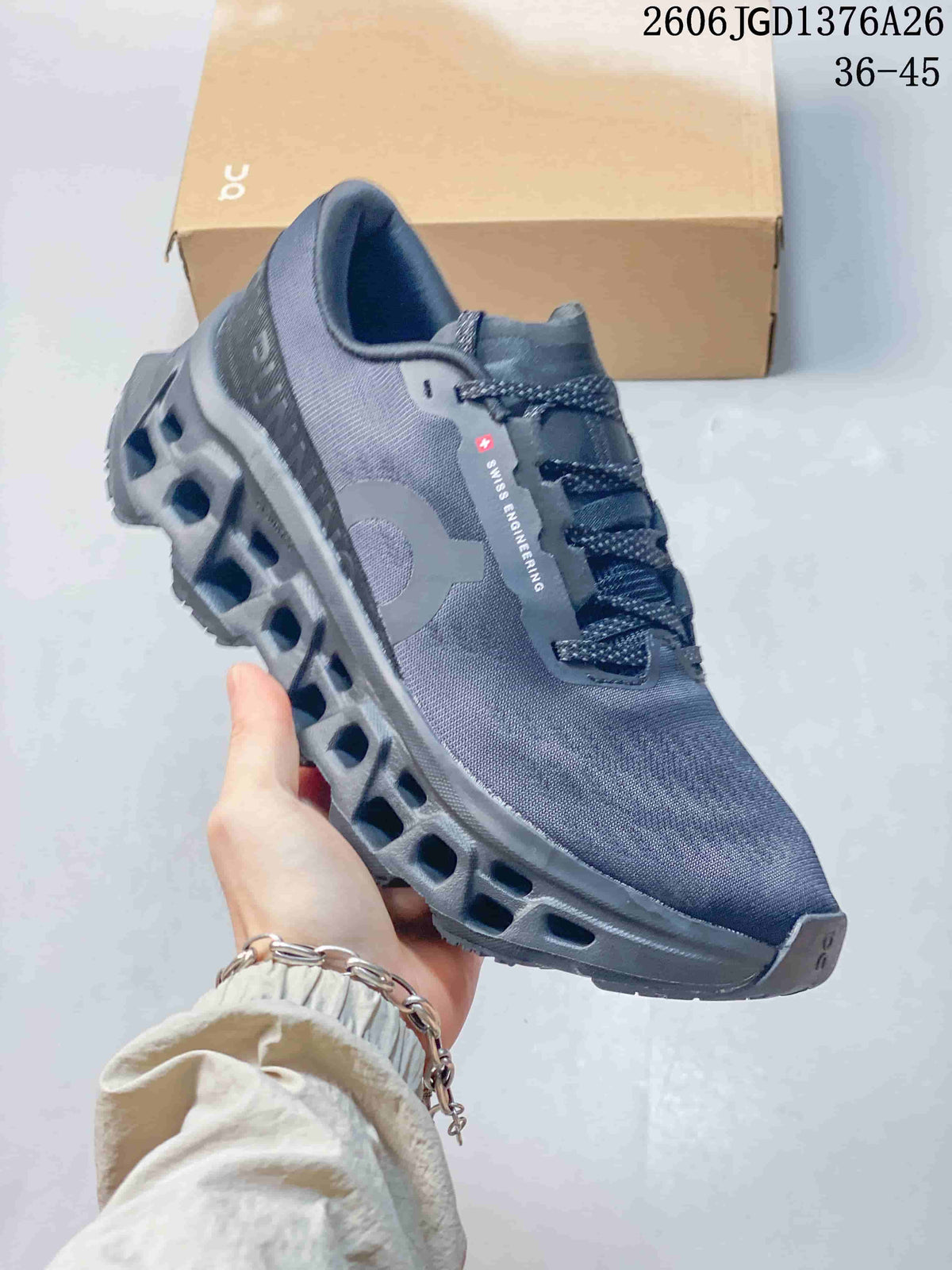 Side view of a dark blue-gray On Cloudmonster 3 shoe