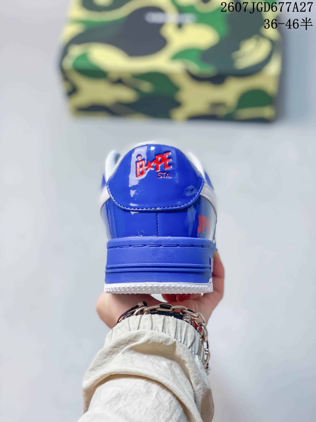 Rear view of a blue BAPE STA sneaker with a white padded collar and BAPE STA branding on the heel tab.