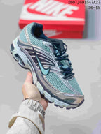 Angled side view of the silver, teal, and black Nike Air Max Moto 2K sneaker.