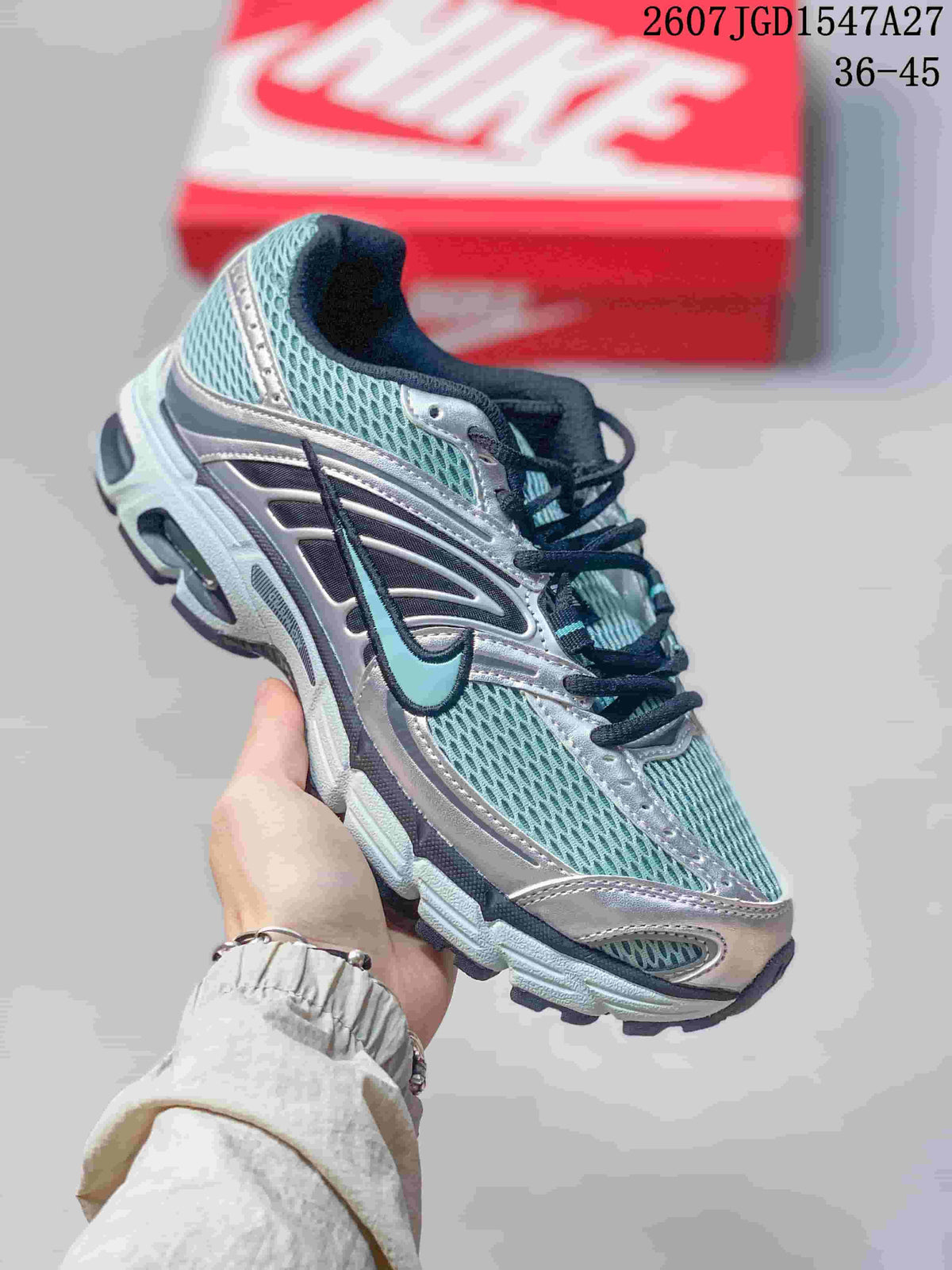 Angled side view of the silver, teal, and black Nike Air Max Moto 2K sneaker.