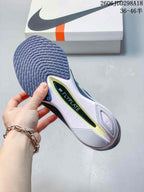 Close-up of the shoe outsole showing a patterned rubber tread, sculpted midsole, and visible FLYPLATE marking.
