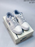 Pair of off-white and grey Nike SB Dunk Low sneakers displayed on a Nike shoe box.