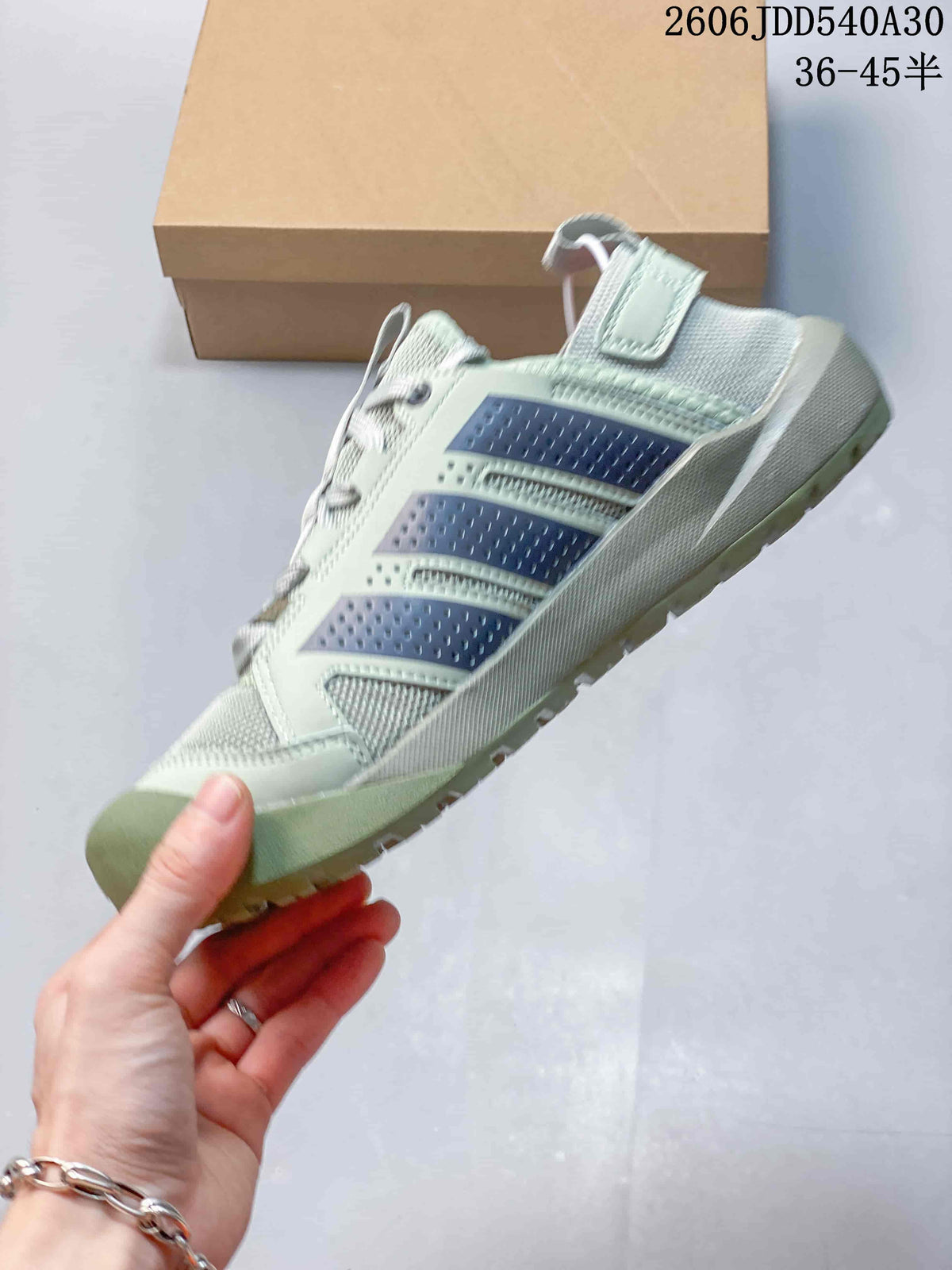 Side view showing the sneaker's dark stripes and textured outsole