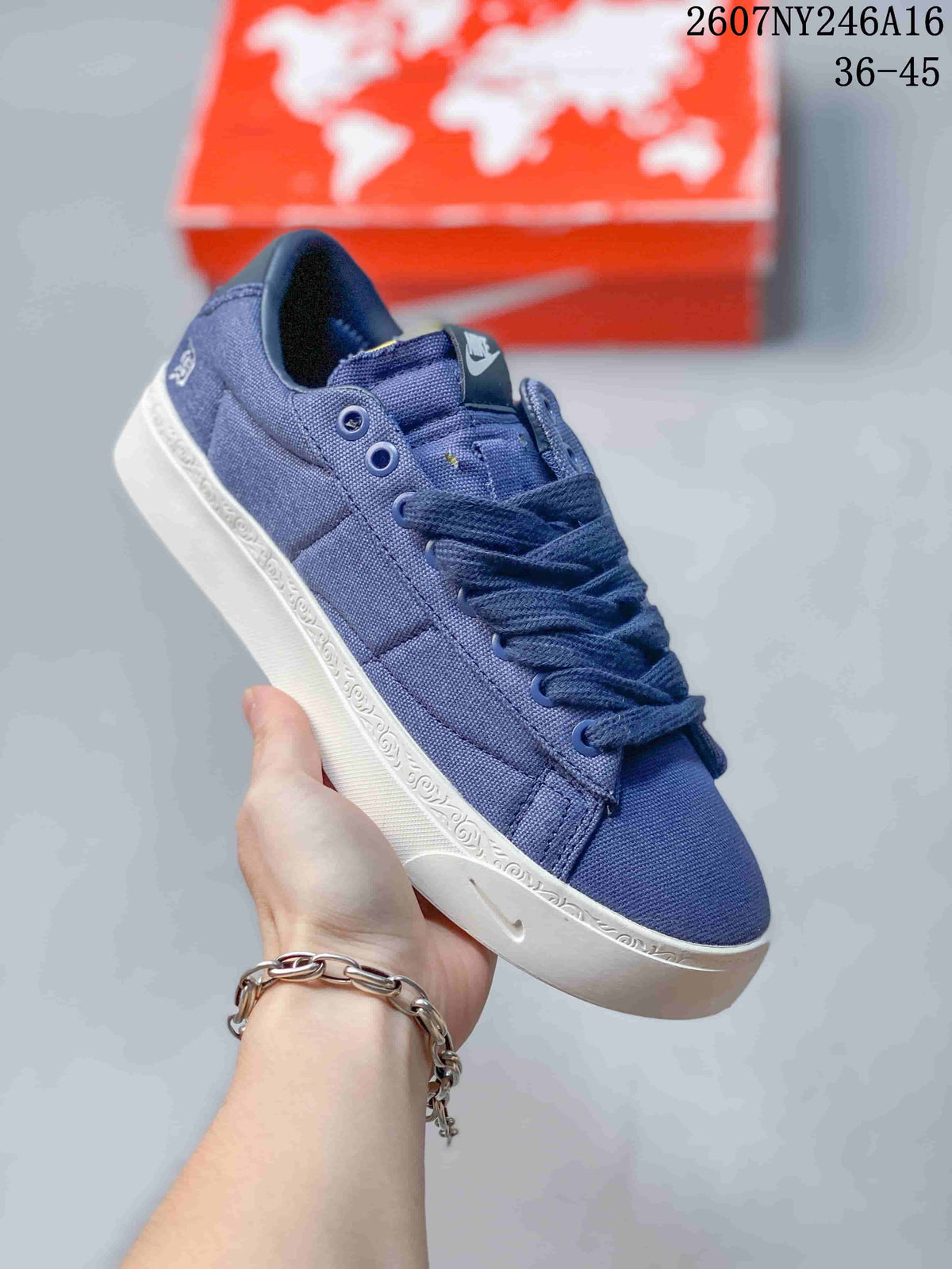 Close-up side view of a solid blue Nike sneaker with a white patterned sole.