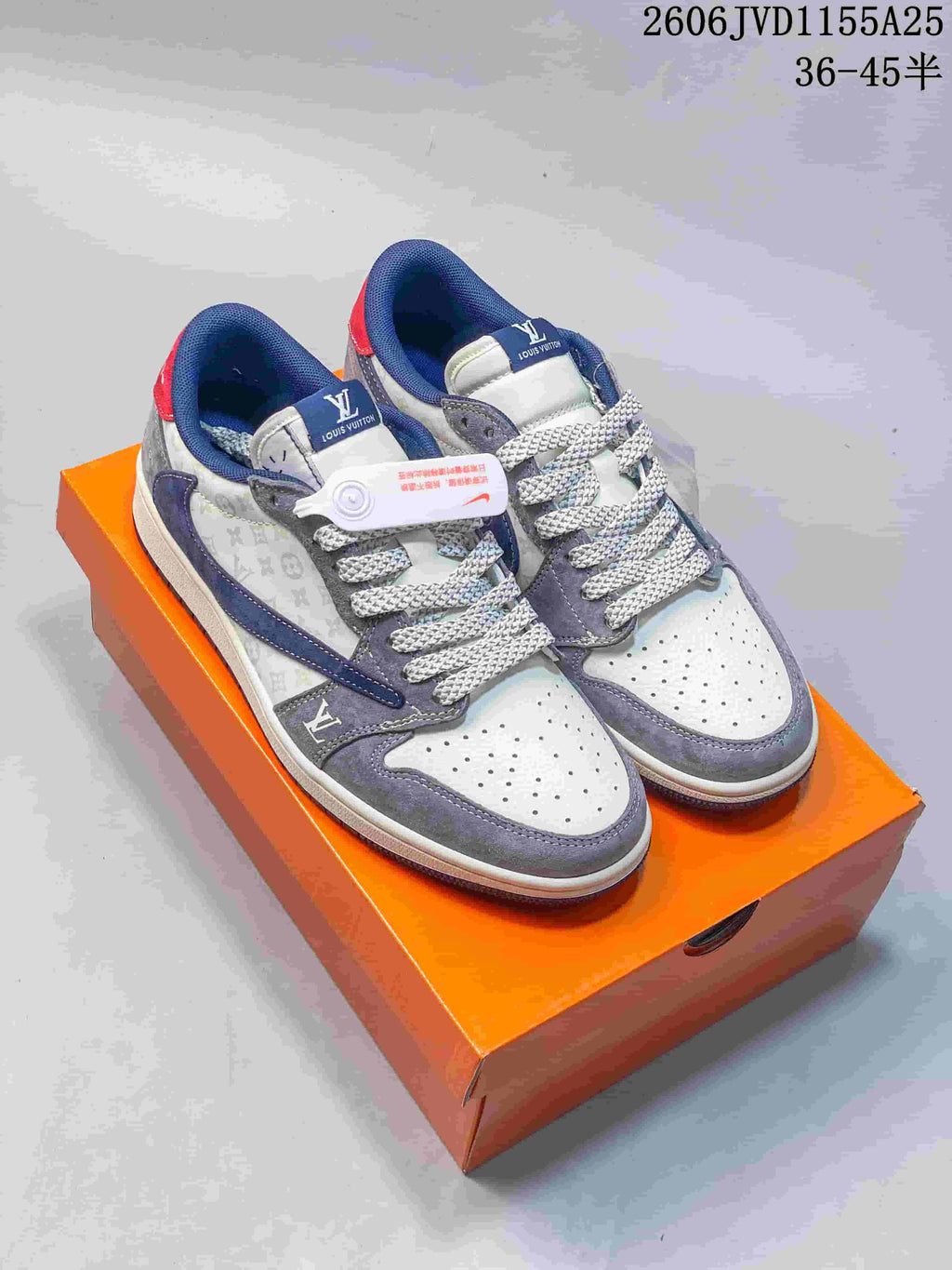 Pair of gray, navy, and pale patterned low-top sneakers displayed on an orange box