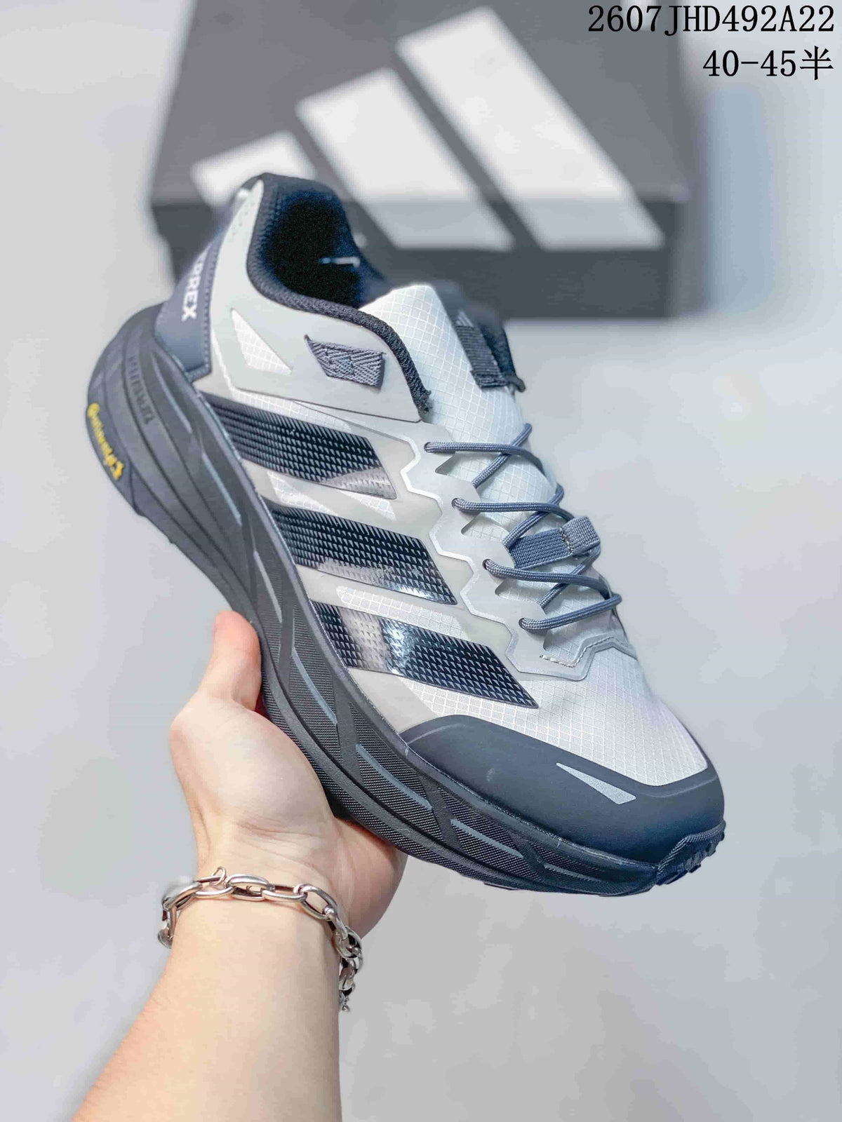 Three-quarter side view showing the Adidas Terrex branding, layered upper and rugged outsole.