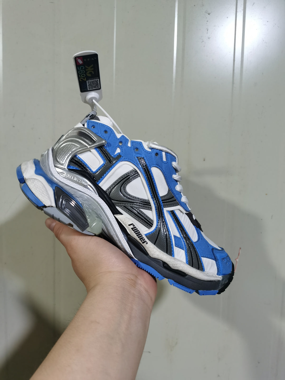 Blue, white and grey Puma Runner sneaker shown from the outer side with layered panels, black detailing and a sculpted sole.