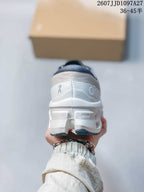 Rear view of the white sneaker showing the padded collar, heel branding, and sculpted sole.