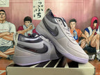 Pair of gray Nike Book 1 low-top shoes with purple outsole accents
