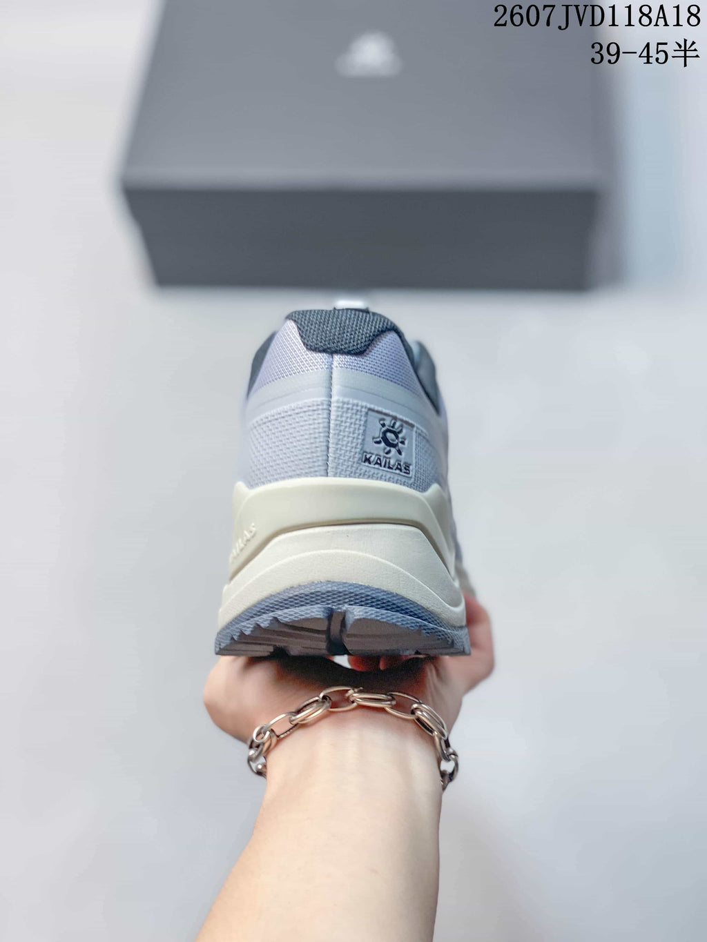 Rear view of the gray sneaker showing the KAILAS heel label, layered heel structure, and outsole tread.