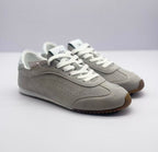 Pair of gray low-top sneakers shown from a front three-quarter angle.