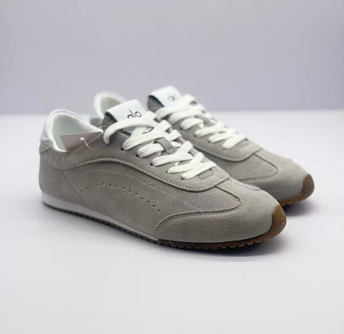 Pair of gray low-top sneakers shown from a front three-quarter angle.